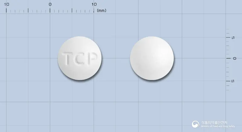 타크론정250밀리그람(티클로피딘염산염)(수출명:CurlemTabs.250mg) 앞뒤 사진 (흰색 원형, 각인 TCP)
