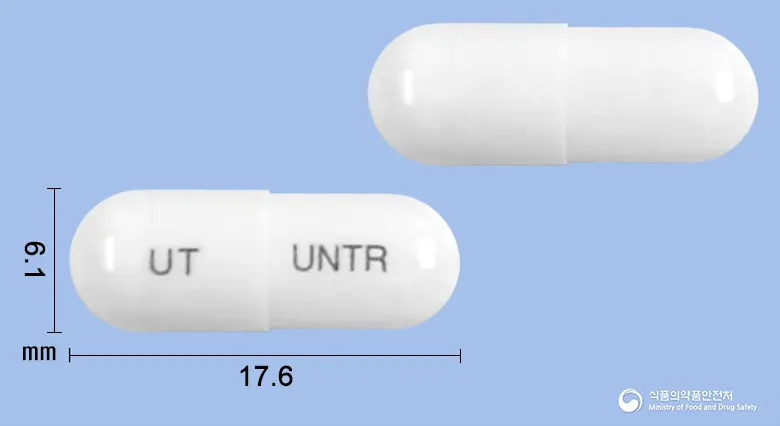 유니토랄캡슐(수출용)(수출명:TefudexCaps.) 앞뒤 사진 (흰색 캡슐, 각인 UT UNTR)