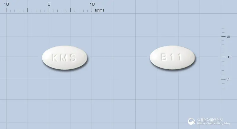 브레날정 앞뒤 사진 (흰색 타원형, 각인 KMS / B11)