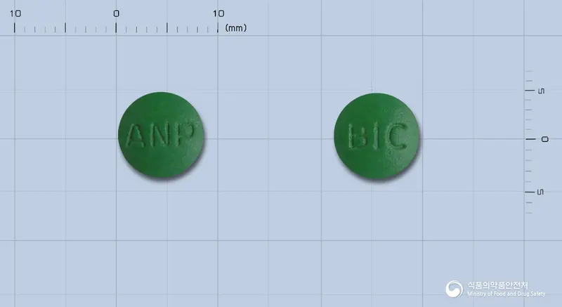 비카린정(수출용) 앞뒤 사진 (초록색 원형, 각인 ANP / BIC)