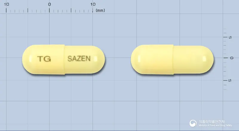 샤젠캡슐(니푸록사지드) 앞뒤 사진 (노란색 캡슐, 각인 TG SAZEN)