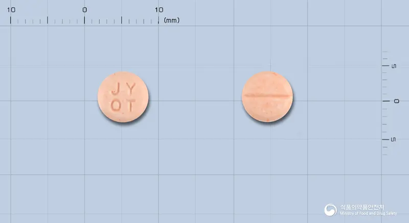 옥티란정40밀리그램(옥틸로늄브롬화물) 앞뒤 사진 (주황색 원형, 각인 JYOT)