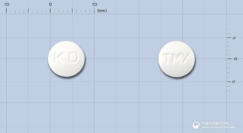 광동타목시펜정10밀리그램(타목시펜시트르산염) 앞뒤 사진 (흰색 원형, 각인 KD / TMX)