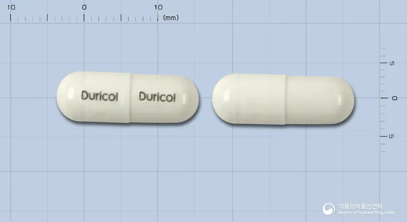 두리콜캅셀 앞뒤 사진 (흰색 캡슐, 각인 Duricol Duricol)