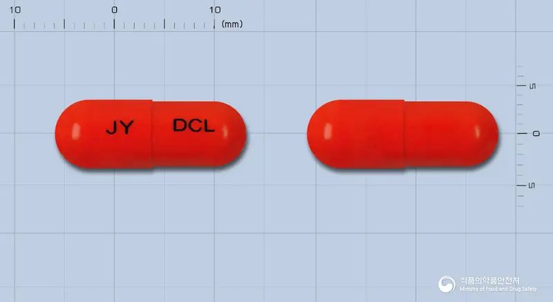 두콜캅셀 앞뒤 사진 (주황색 캡슐, 각인 JY DCL)