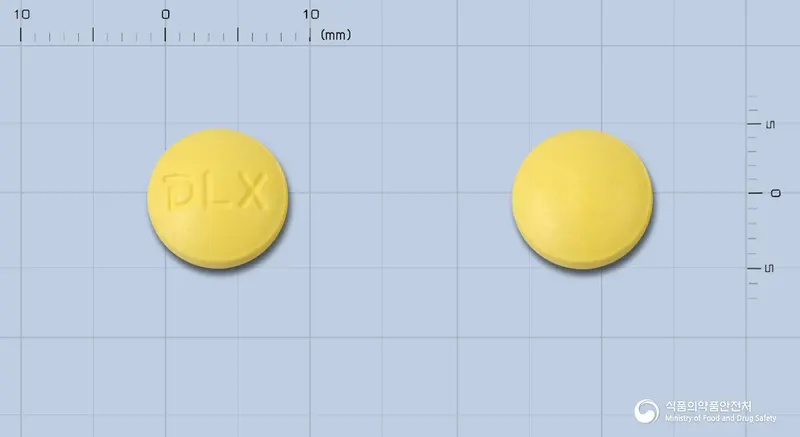 라복센정(염산플라복세이트) 앞뒤 사진 (노란색 원형, 각인 LX)