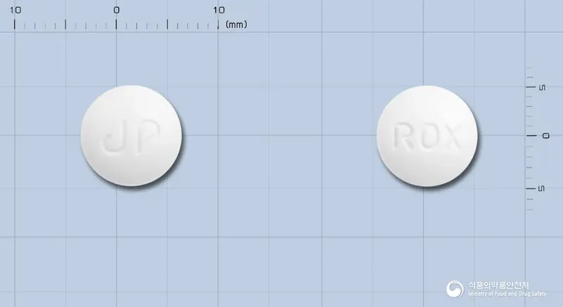 록신마이신정(록시트로마이신)(수출명:Roxin) 앞뒤 사진 (흰색 원형, 각인 ROX)