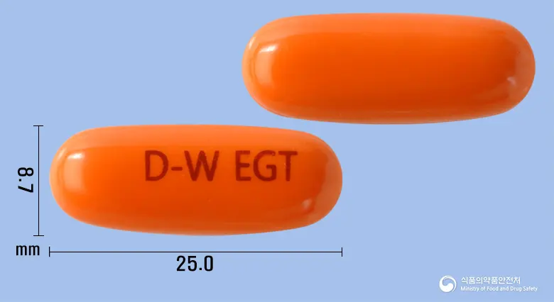 동화엘기톤연질캡슐(엘시스틴) 앞뒤 사진 (주황색 캡슐, 각인 D-W EGT)