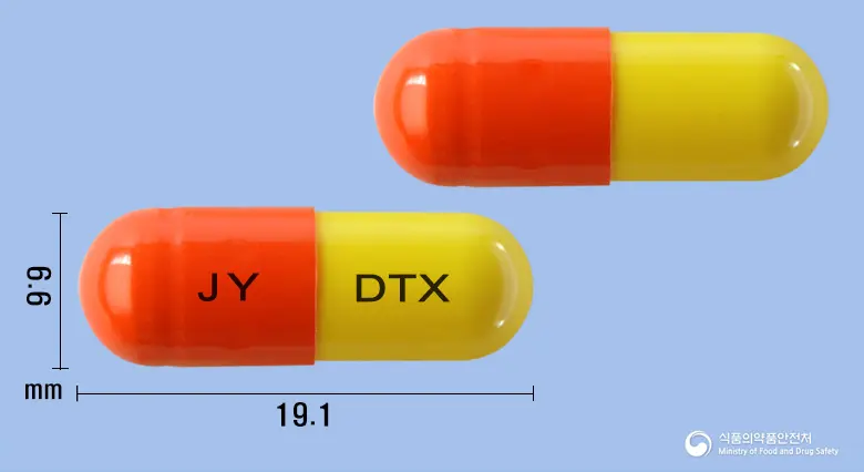 덴탁스캡슐 앞뒤 사진 (주황색 캡슐, 각인 JY DTX)