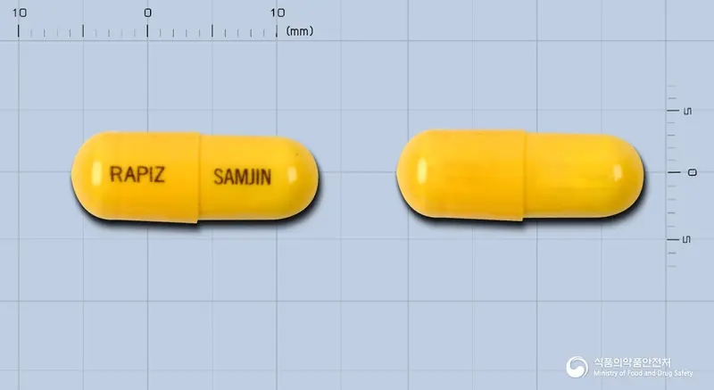 레피즈캡슐(니푸록사지드) 앞뒤 사진 (노란색 캡슐, 각인 RAPIZ SAMJIN)