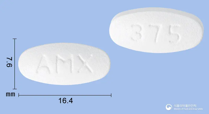 오그멕스정375밀리그램(아목시실린수화물,클라불란산칼륨)(수출명:Zamex tabs.250mg/125mg) 앞뒤 사진 (흰색 타원형, 각인 AMX / 375)