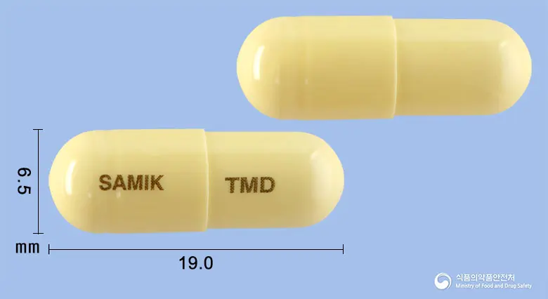 치엠디캡슐(치모모둘린)(수출명: Samiktiemdi Capsule, HUERSICAM Cap.)(수출용) 앞뒤 사진 (노란색 캡슐, 각인 SAMIK TMD)