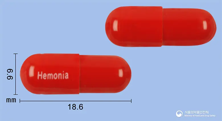 헤모니아캡슐(폴리사카리드철착염) 앞뒤 사진 (빨간색 캡슐, 각인 Hemonia)