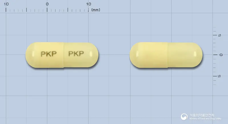 에치탑캡슐 앞뒤 사진 (노란색 캡슐, 각인 PKP PKP)