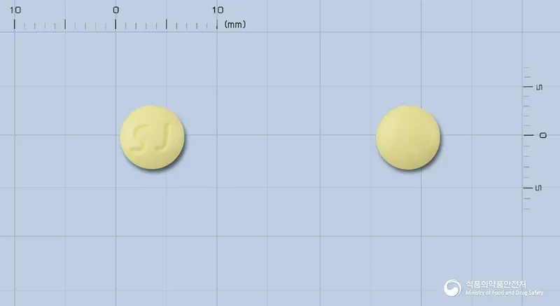 쎌라트바클로펜정10mg(수출용) 앞뒤 사진 (노란색 원형, 각인 SJ)