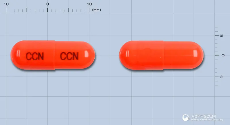 한신치코날에스캡슐 앞뒤 사진 (주황색 캡슐, 각인 CCN CCN)