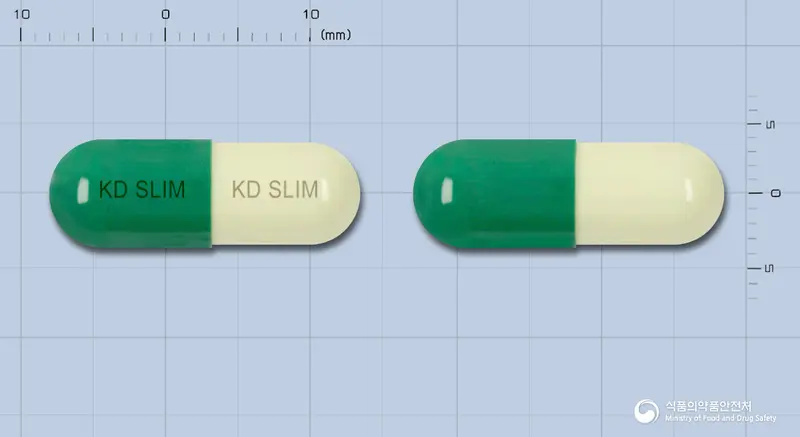 슬라임캡슐 앞뒤 사진 (초록색 캡슐, 각인 KD SLIM KD SLIM)