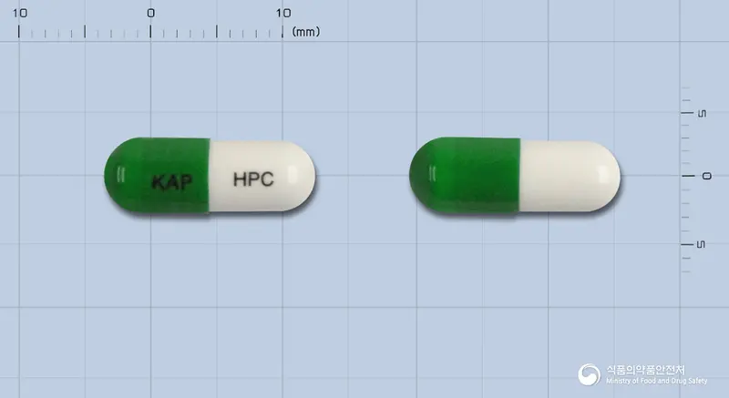 해피코프에스캡슐 앞뒤 사진 (초록색 캡슐, 각인 KAP HPC)