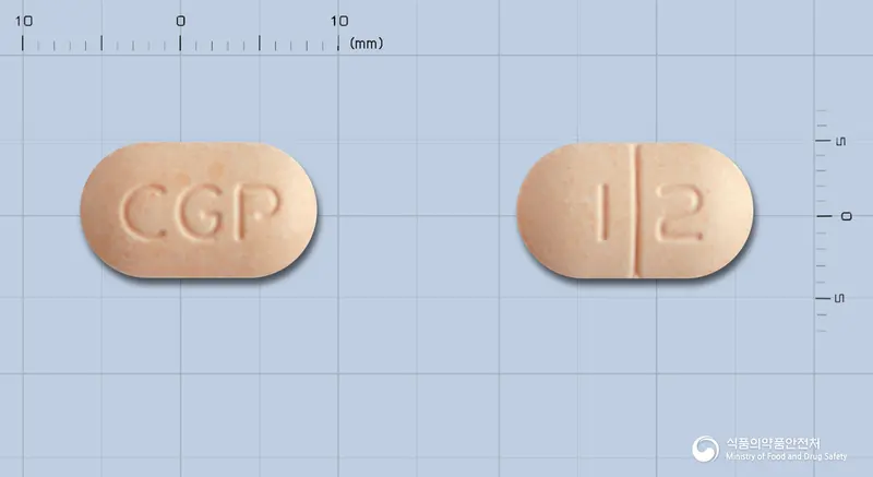 후리졸정(알벤다졸) 앞뒤 사진 (분홍색 장방형, 각인 CGP / 1 2)