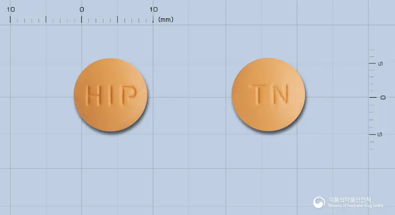 탈메드정(탈니플루메이트) 앞뒤 사진 (주황색 원형, 각인 HIP / TN)
