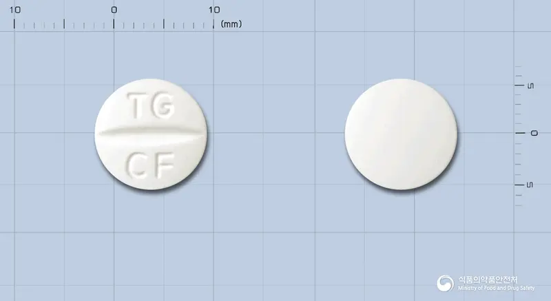 태극염산시프로플록사신정(수출명 : STACIPRO TABLET) 앞뒤 사진 (흰색 원형, 각인 TG CF)