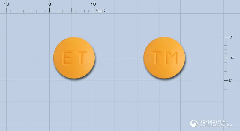 타말겐정(탈니플루메이트) 앞뒤 사진 (주황색 원형, 각인 ET / TM)