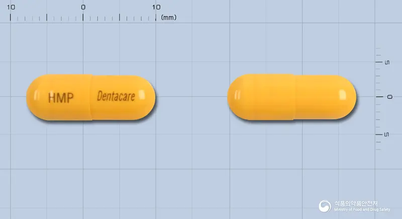 덴타케어캡슐(수출용) 앞뒤 사진 (주황색 캡슐, 각인 HMP Dentacare)