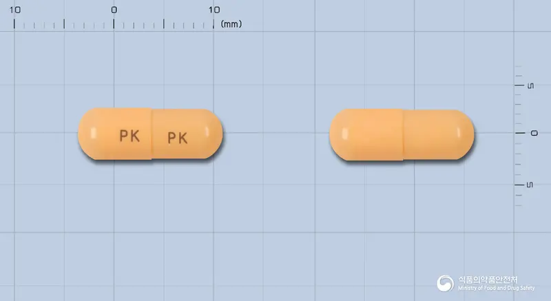 쎄팍캡슐(세픽심)(수출용) 앞뒤 사진 (주황색 캡슐, 각인 PK PK)