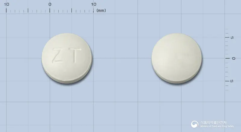 잔티팜정 앞뒤 사진 (흰색 원형, 각인 ZT)
