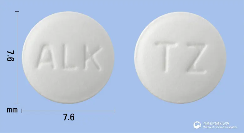 티로진정(티로프라미드염산염) 앞뒤 사진 (흰색 원형, 각인 ALK / TZ)