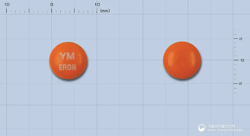 에론정(염산에페리손) 앞뒤 사진 (주황색 원형, 각인 YMERON)