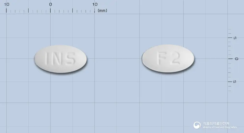 인스메토린정(메토카르바몰) 앞뒤 사진 (흰색 타원형, 각인 INS / F2)