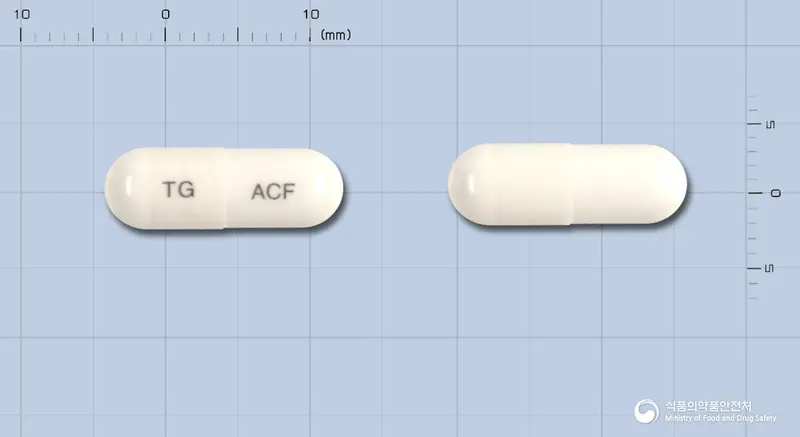 올콜에프캡슐 앞뒤 사진 (흰색 캡슐, 각인 TG ACF)