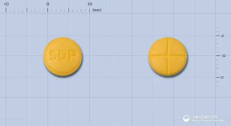 우리들토피라메이트정100mg(수출용) 앞뒤 사진 (노란색 원형, 각인 SDP)
