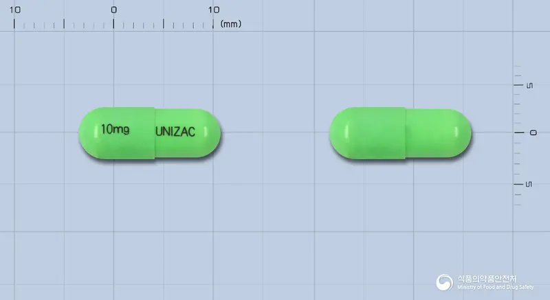 유니작캡슐10밀리그람(염산플루옥세틴) 앞뒤 사진 (연두색 캡슐, 각인 10mg UNIZAC)