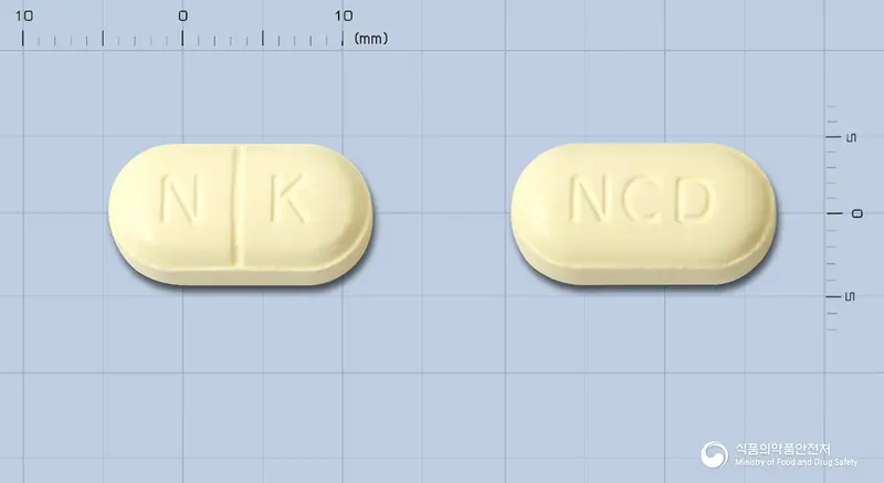 넥시드에프정 앞뒤 사진 (노란색 장방형, 각인 N K / NCD)