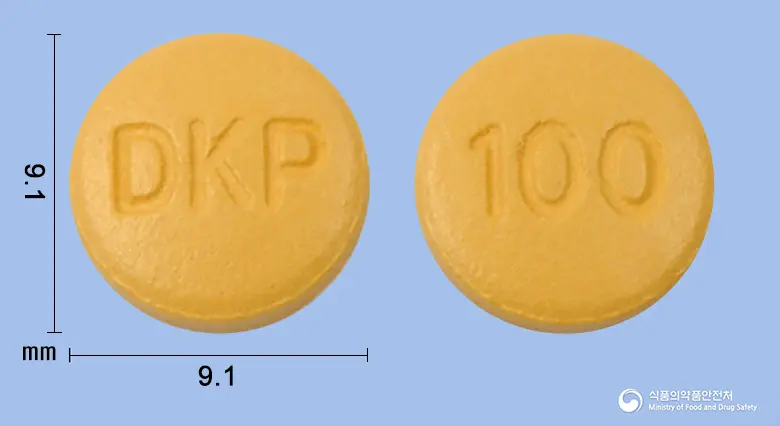 토프람정100mg(토피라메이트)(수출용) 앞뒤 사진 (노란색 원형, 각인 DKP / 100)
