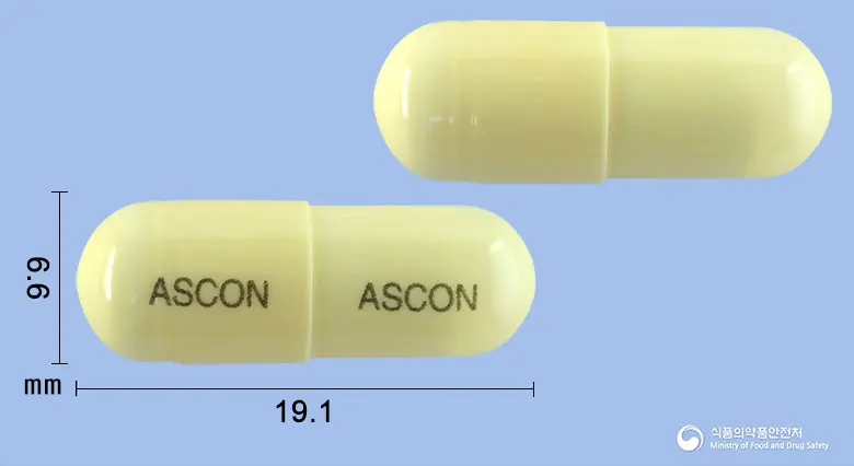 아스콘에이캡슐 앞뒤 사진 (노란색 캡슐, 각인 ASCON ASCON)