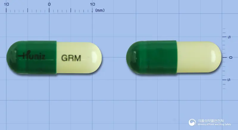 그린엠캡슐 앞뒤 사진 (초록색 캡슐, 각인 GRM)