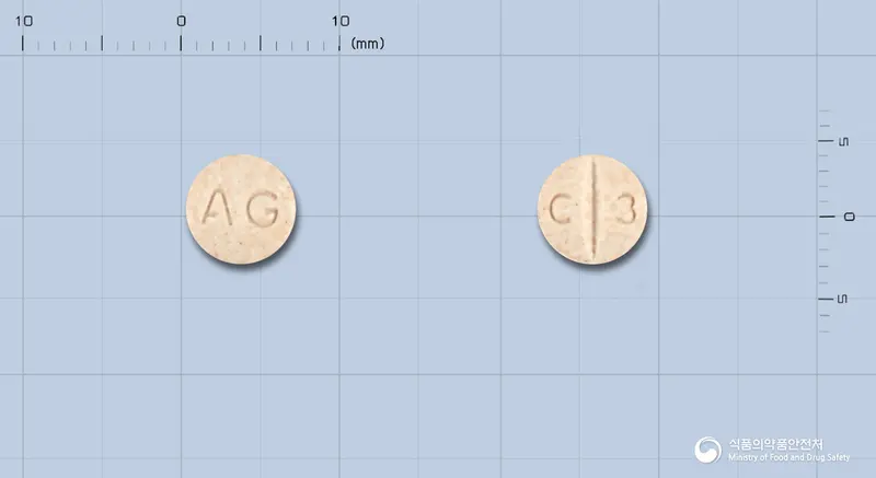 안국카르베딜롤정12.5밀리그램 앞뒤 사진 (주황색 원형, 각인 AG / C 3)