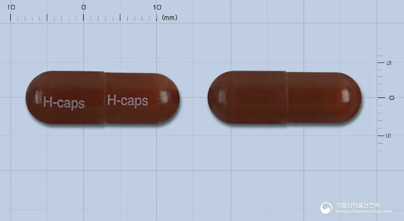 헤모로얄캡슐 앞뒤 사진 (갈색 캡슐, 각인 H-caps H-caps)