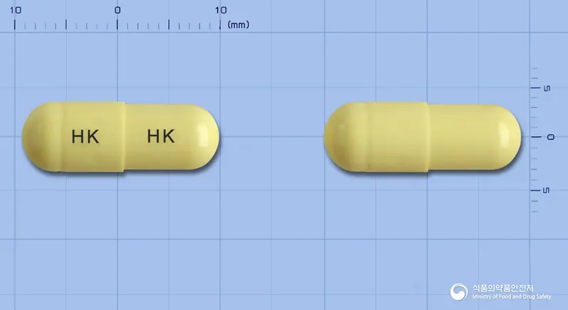 비오페린캡슐 앞뒤 사진 (노란색 캡슐, 각인 HK HK)