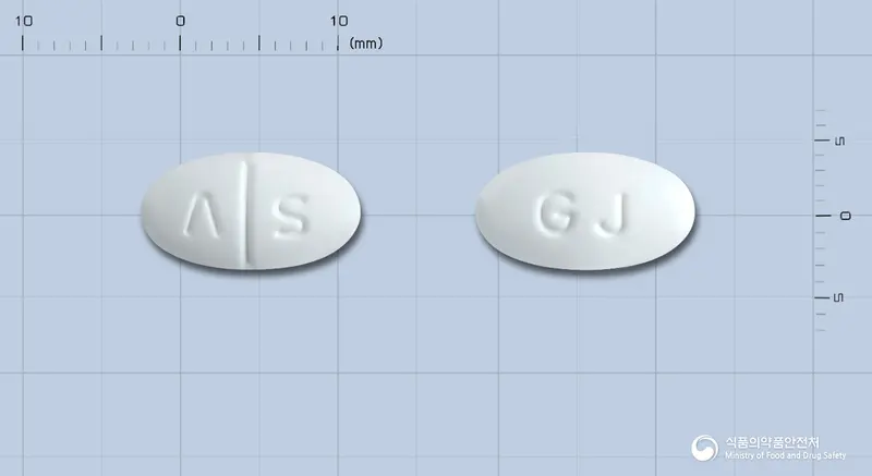 애니사탄정(이베사탄) 앞뒤 사진 (흰색 타원형, 각인 Λ S / GJ)