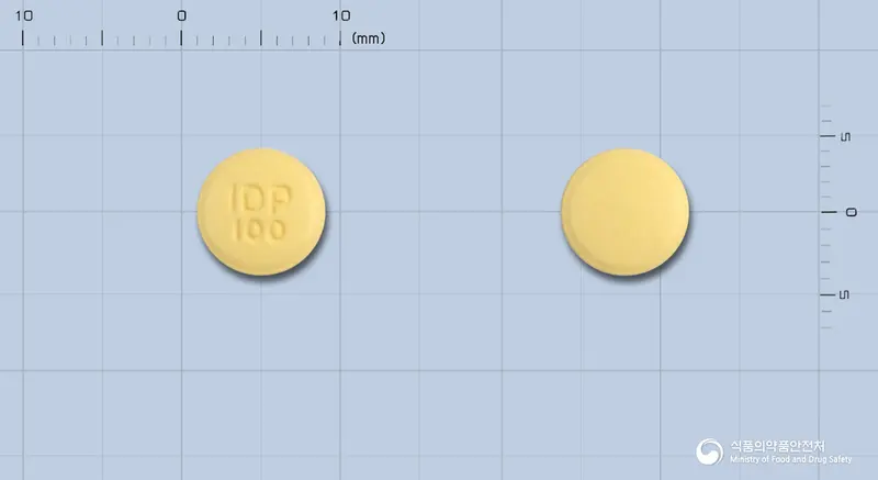 큐티핀정100밀리그램(쿠에티아핀푸마르산염) 앞뒤 사진 (노란색 원형, 각인 IDP100)
