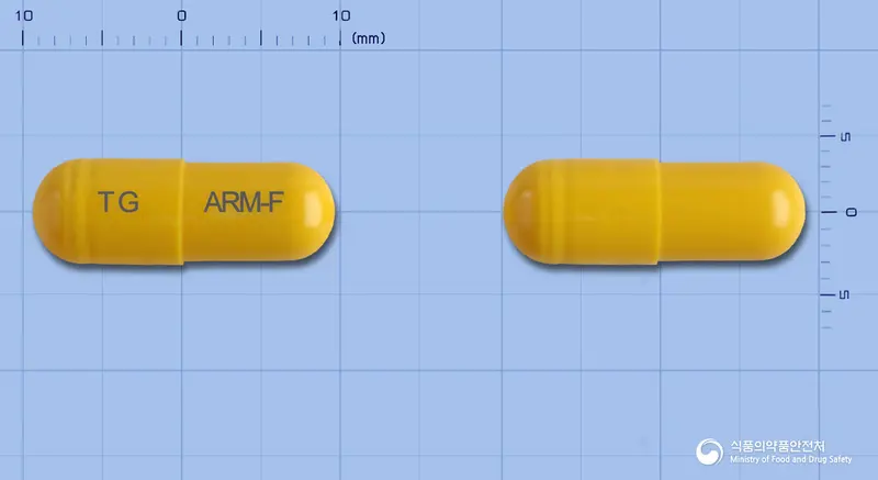 아로마에프캡슐 앞뒤 사진 (노란색 캡슐, 각인 TG ARM-F)