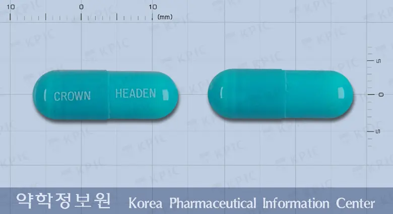 헤덴캡슐 앞뒤 사진 (파란색 캡슐, 각인 CROWN HEADEN)