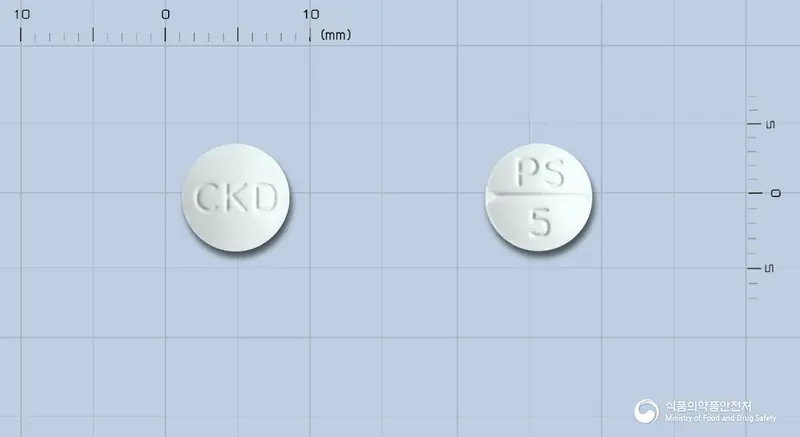 싸이렉사정5밀리그램(올란자핀)(수출용) 앞뒤 사진 (흰색 원형, 각인 CKD / PS 5)