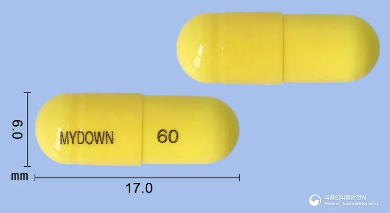 마이다운캡슐60밀리그램(오르리스타트) 앞뒤 사진 (노란색 캡슐, 각인 MYDOWN 60)