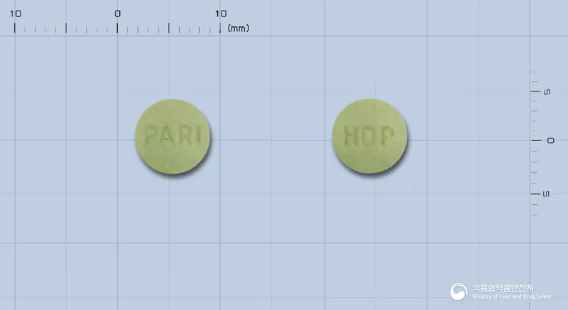 파로킨정1mg(로피니롤염산염) 앞뒤 사진 (연두색 원형, 각인 PAR1 / HDP)