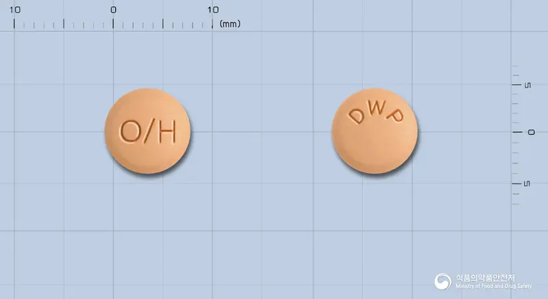 올메르탄플러스정 앞뒤 사진 (주황색 원형, 각인 O/H / DWP)